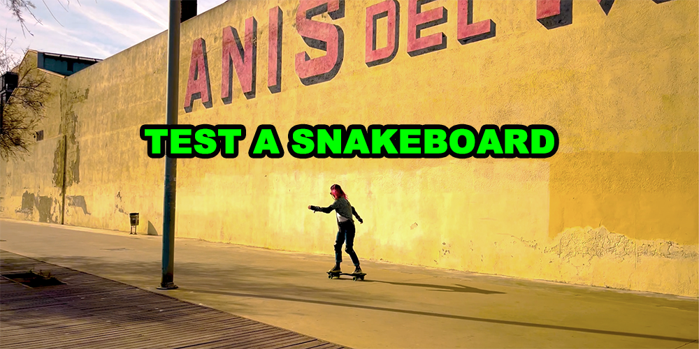 TEST A SNAKEBOARD WITH A GIRL WITH PINK HAIR SNAKEBOARDING IN THE BACKGROUND